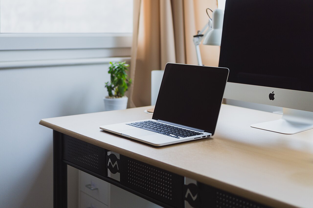 A neat, empty desk with a laptop, ready but untouched